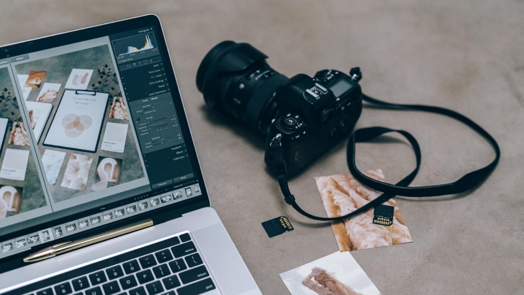 A laptop and camera on a table